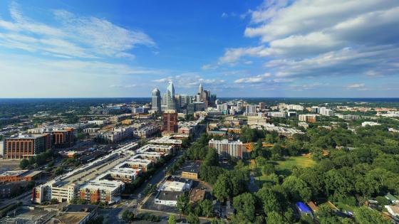a view of the Charlotte skyline on a sunny blue skies day