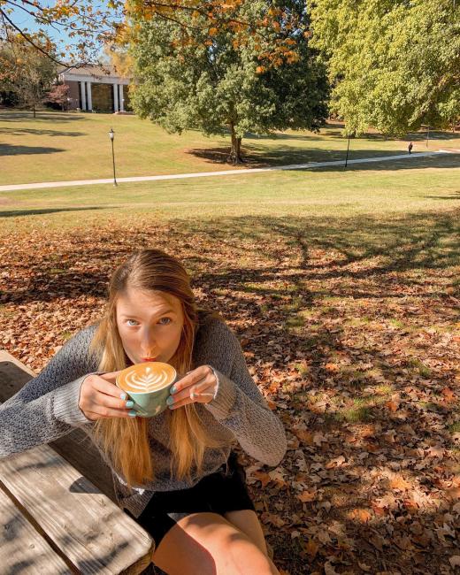 student enjoys a cup of coffee at Summit