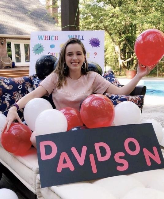 Admitted student with balloons and Davidson sign