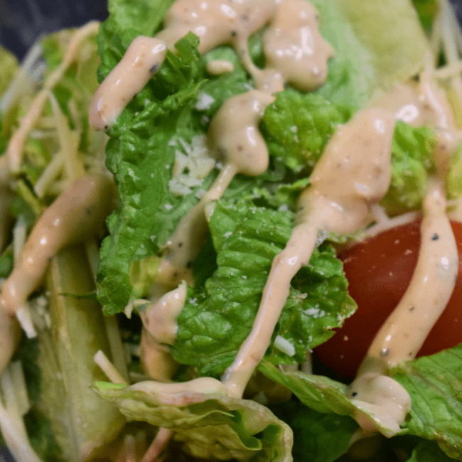 a caesar salad with dressing
