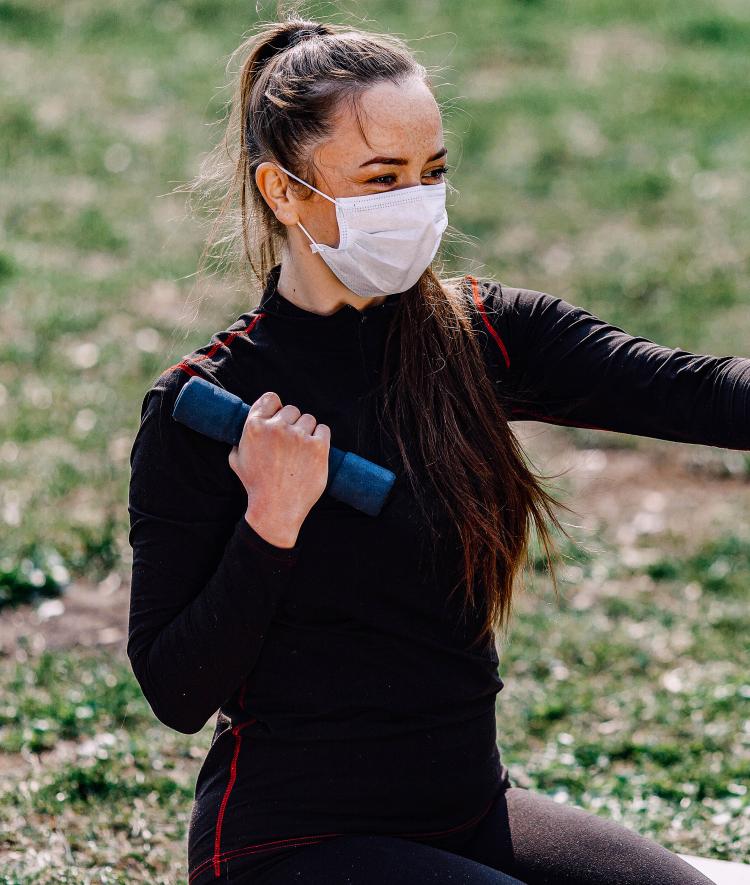 Woman Lifting Weights Outside Wearing Masks