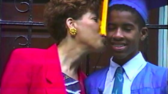 Family member kisses son on cheek, screenshot of documentary