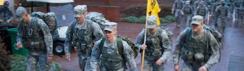 ROTC students in full uniform with gear walk the campus
