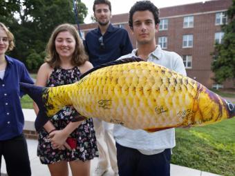 Students hold fish, "Honor Cod"