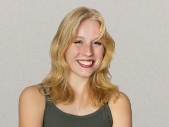 a young white woman with blonde hair wearing a green tank top