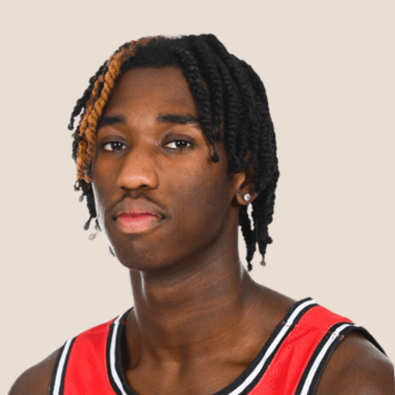 a young Black man wearing a red basketball jersey