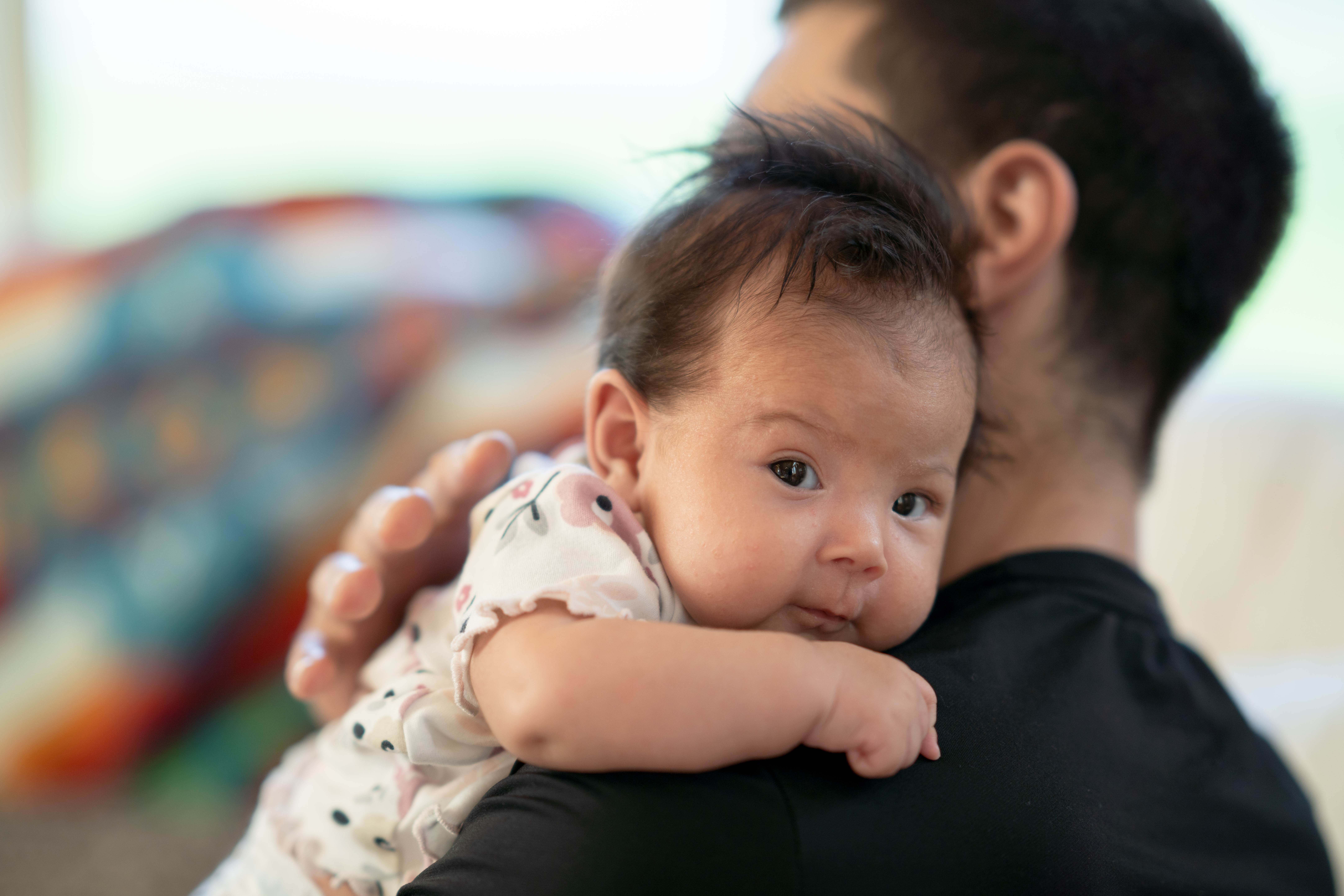 Baby on father's shoulder