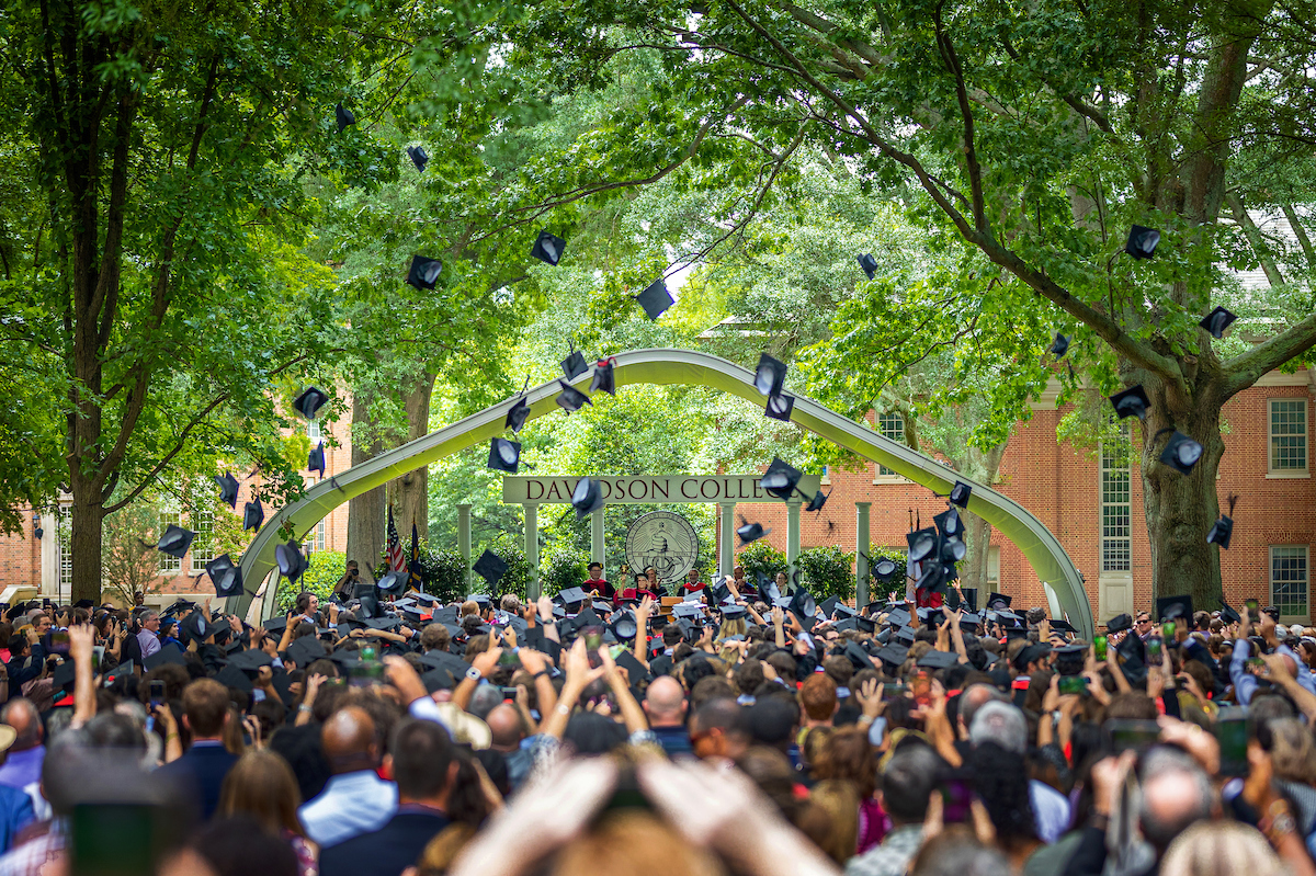 students throwing their caps in the air at commencement