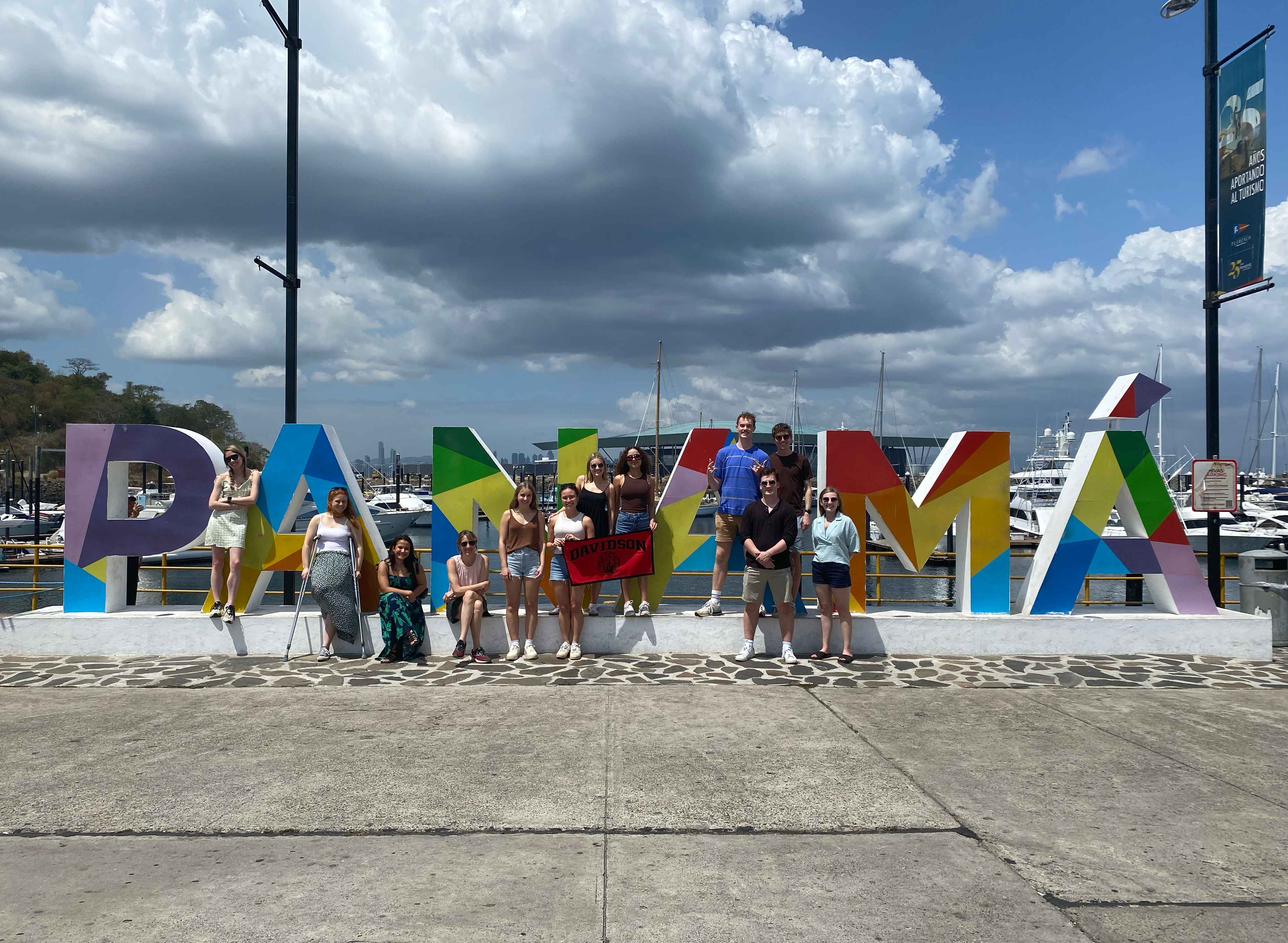 a group of students stand in front of a sign that reads "Panama"