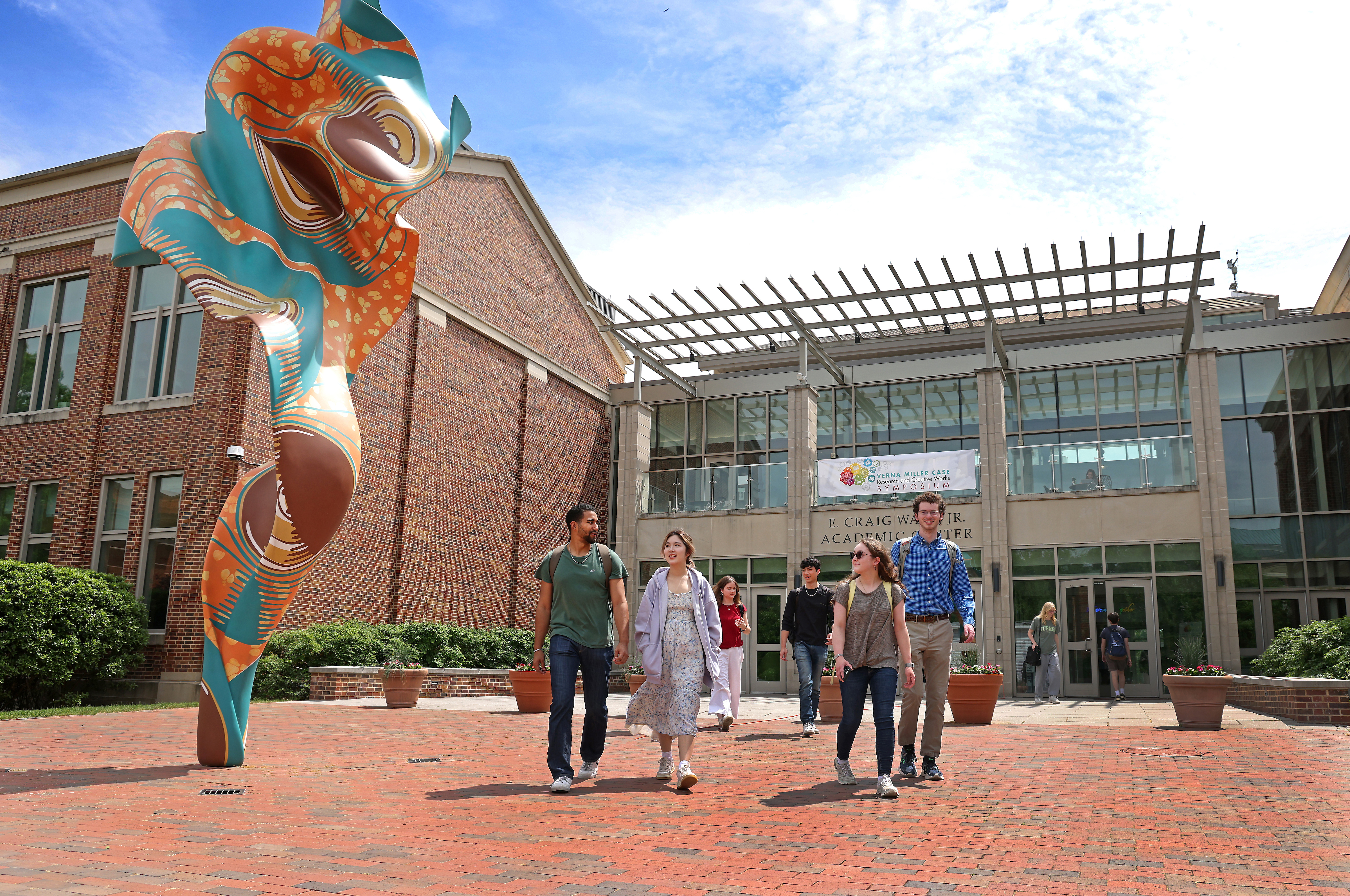 A group of students walking together outside an academic building