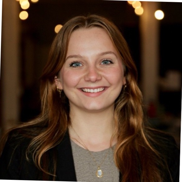 a young white woman wearing a blazer