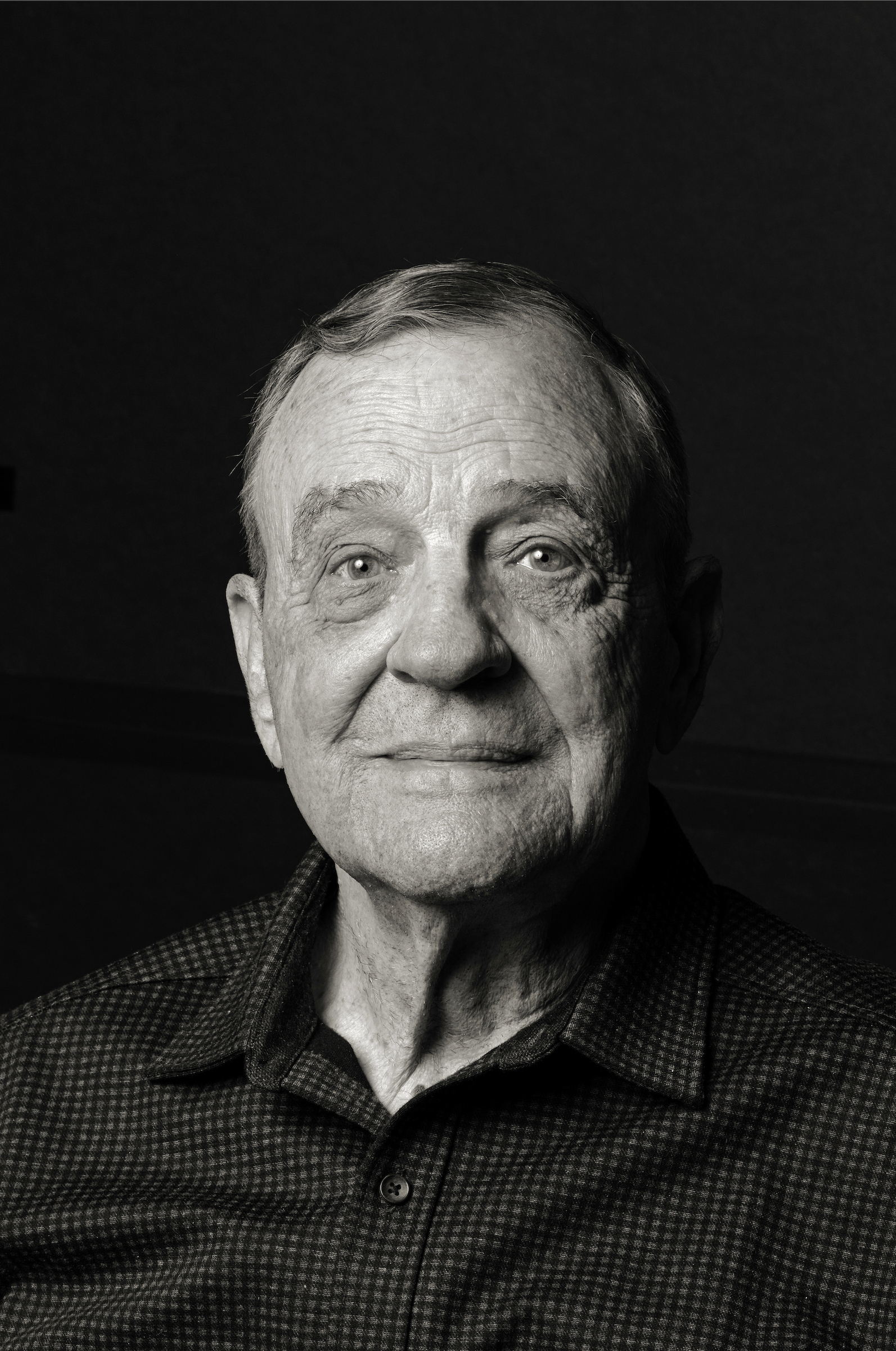 older man with dark hair and neutral expression