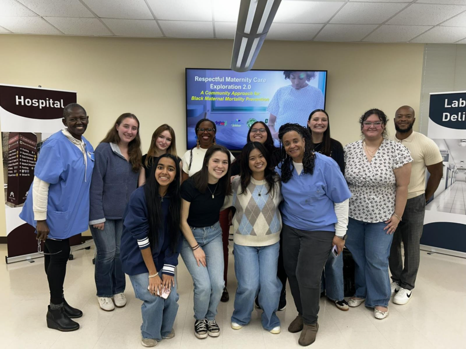 a group of students and adults in scrubs standing together and smiling