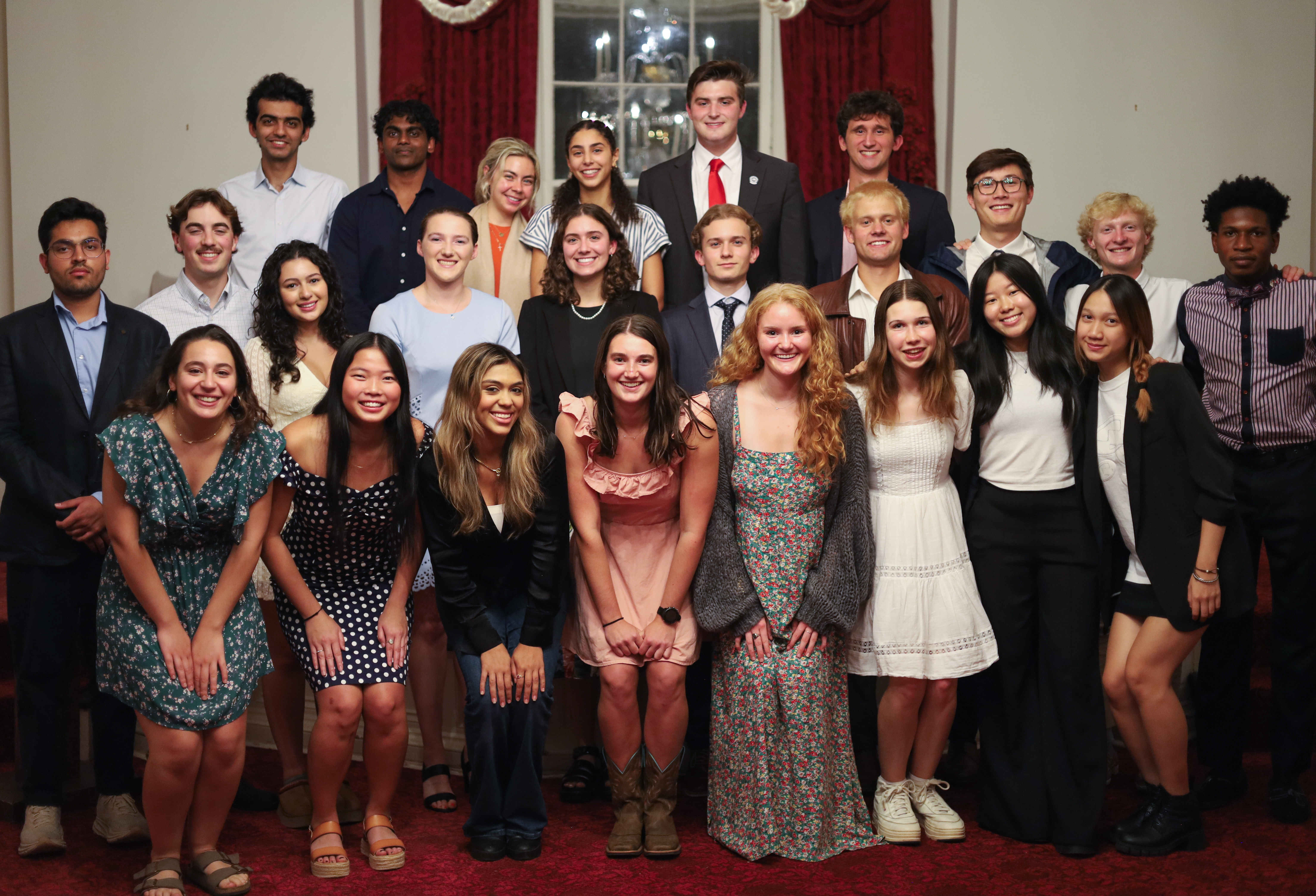 A group of diverse university students in semi-formal attire pose for a multi-row group portrait during a 2026 Student Government Association meeting.