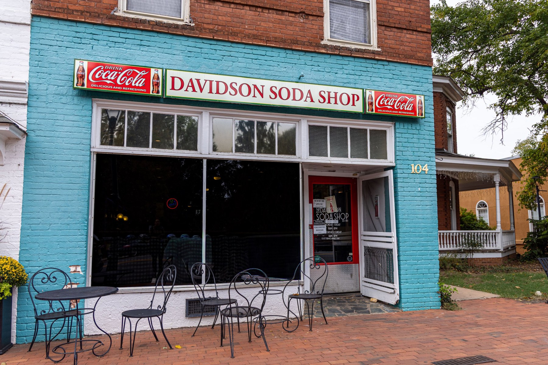 Now: the Davidson Soda Shop storefront today, painted teal with outdoor tables