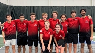 a group of pickleball players on an indoor court wearing red uniforms