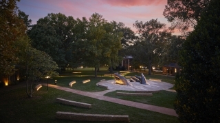A sculpture in front of a colorful sunset on Davidson's Campus