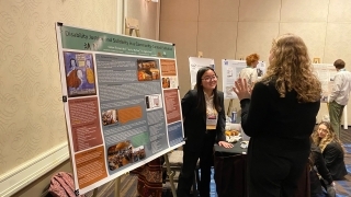 a young woman presents at a conference 