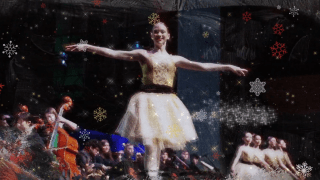 2026 Holiday Video Still Ballerina on stage with orchestra to the side