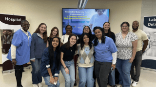 a group of students and adults in scrubs standing together and smiling