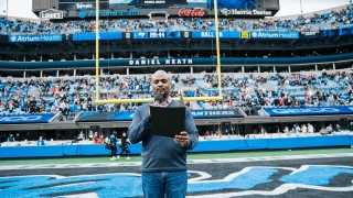 Daniel Heath reading to the crowd as the inaugural chaplain for Charlotte Football Club (Charlotte FC),