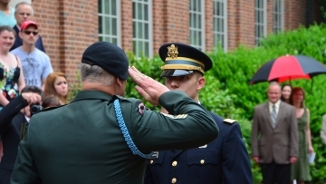 Military official salutes ROTC student outside