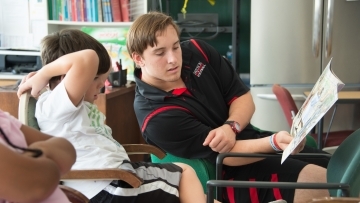 Sociology student reads book to small child