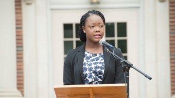 Jocelyn Kennedy '17 stands at podium in front of Chambers for the Law School Induction Ceremony