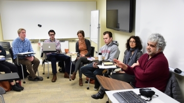 Arab studies class arranges desk in a circle while listening to a discussion led by Khaled Khalifa, a Syrian screenwriter and novelist