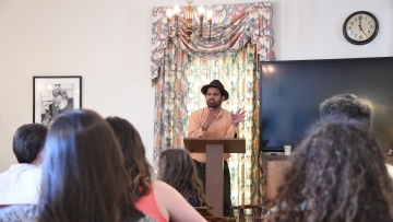 Students heads face Prof. Zamir as he stands at a podium and speaking