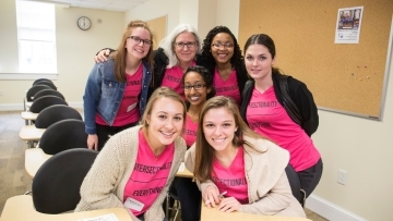 Women's Leadership Conference speakers gather in a classroom