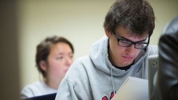 Student analyzes paper in class