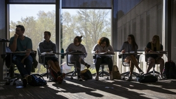 Wall Center Students sitting at desks in class with window behind