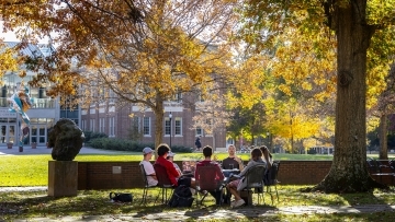 Prof. Patricio Boyer and Students gather outside on a beautiful fall day