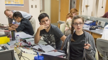 students discussing in physics lab