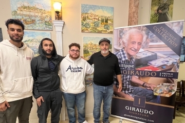 a group of students with an older artist standing together
