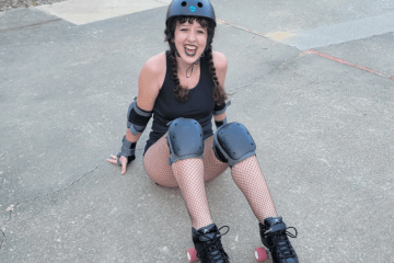 a young woman in roller skates and a helmet smiling