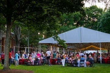 a tent surrounded by string lights at dusk