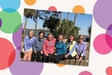 a group of women sitting together in a sunny coastal location