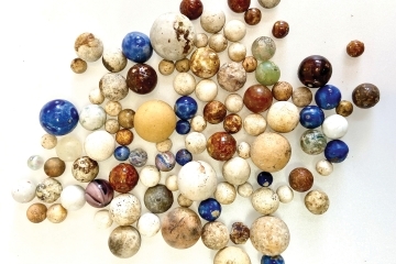 Colorful marbles of all sizes on a white background