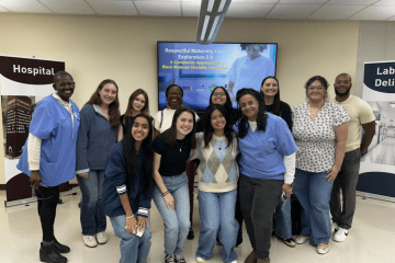 a group of students and adults in scrubs standing together and smiling