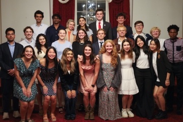 A group of diverse university students in semi-formal attire pose for a multi-row group portrait during a 2026 Student Government Association meeting.