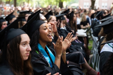 Student smiles and claps at Commencement 2026
