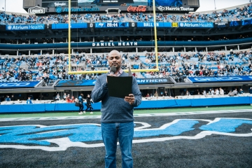 Daniel Heath reading to the crowd as the inaugural chaplain for Charlotte Football Club (Charlotte FC),