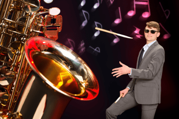 A giant saxophone and student with a drumstick