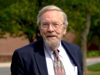 Hansford M. Epes stands and smiles at the camera while wearing a suit