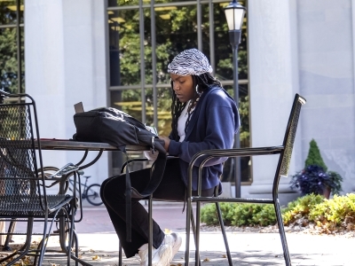 Student on laptop sitting outside