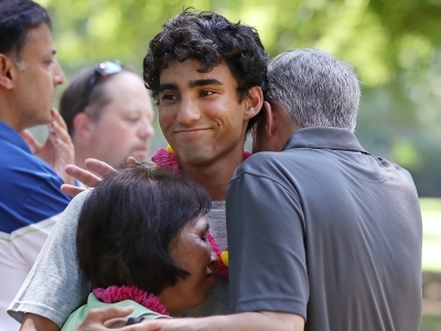 Family embraces at outdoor picnic