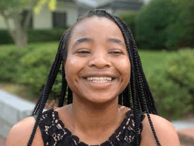 a young Black woman smiling