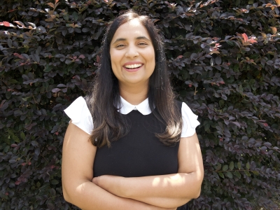 a young woman wearing a white collar and black top